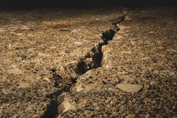 Split ground covered in stones under the sunlight with a blurry background